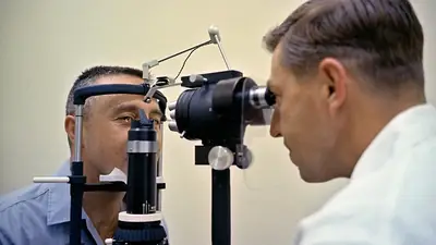 An eye doctor examining a patient with a slit lamp